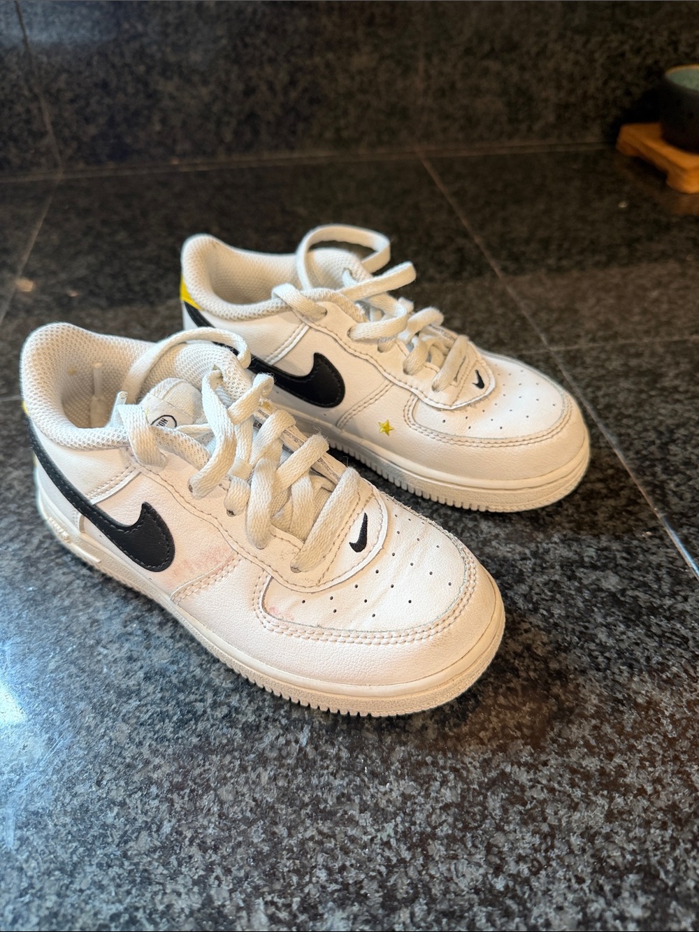 Nike Kids White Sneakers with Black Swoosh and Yellow Star